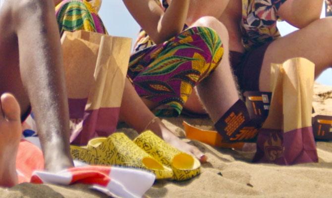 Friends enjoying burgers for lunch on the beach