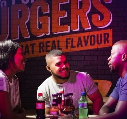 Three people sitting at a steers restaurant