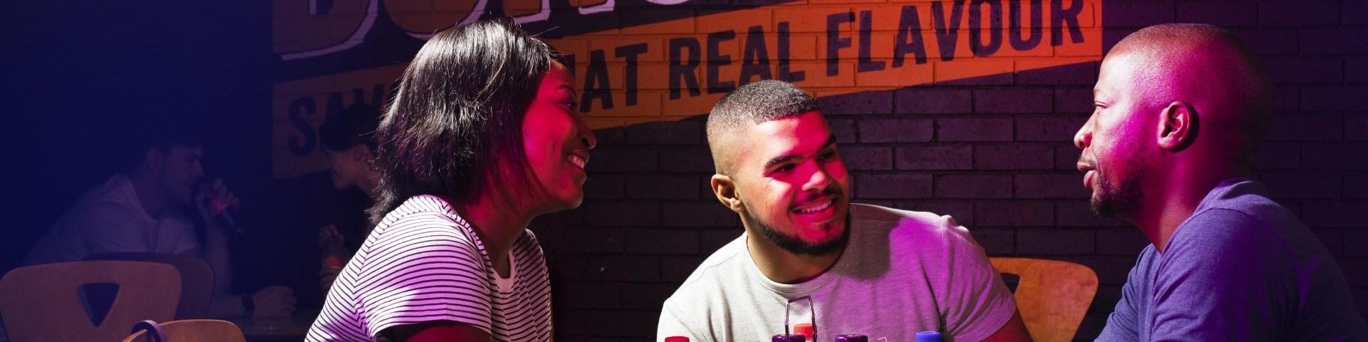 Three people sitting at a steers restaurant
