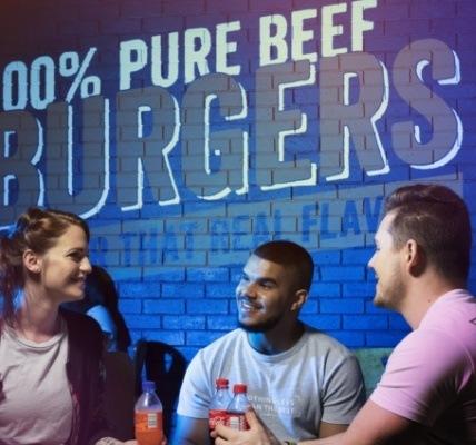 Three people sitting at a steers restaurant