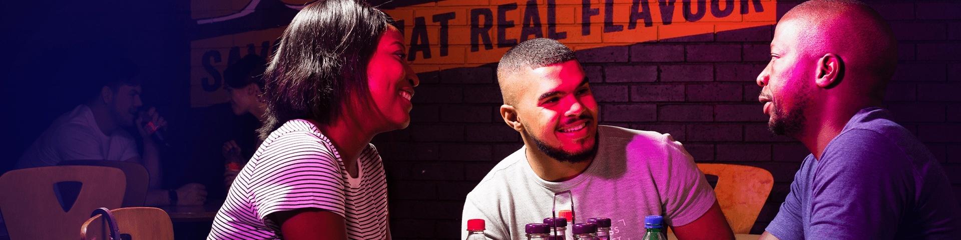 Three people sitting at a steers restaurant
