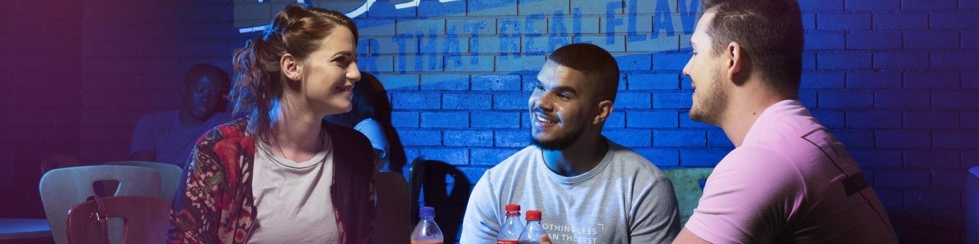Three people sitting at a steers restaurant