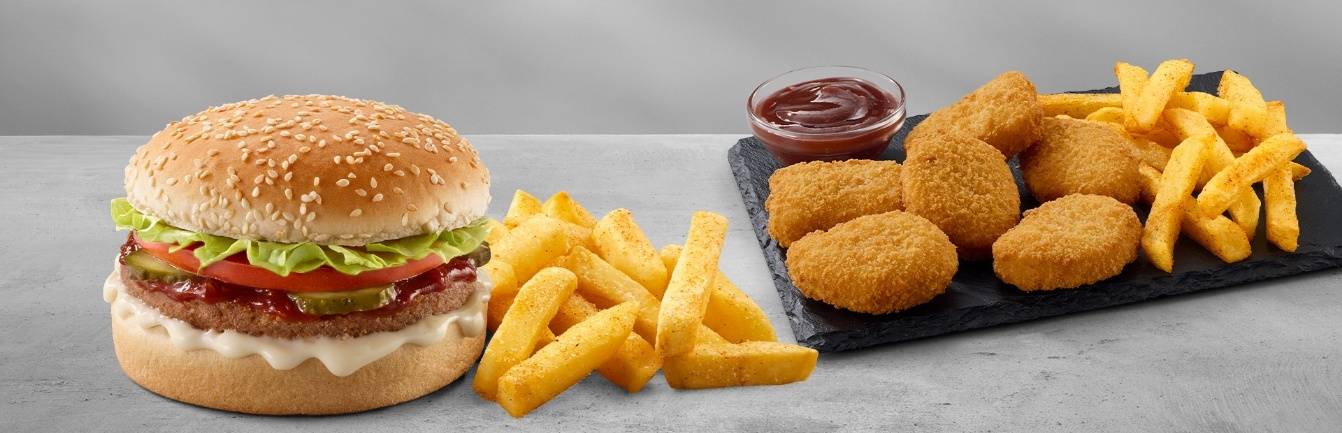 Burger combo meal with lettuce, tomato, pickles, creamy mayo sauce, crispy French fries, crispy chicken nuggets, and ketchup dip
