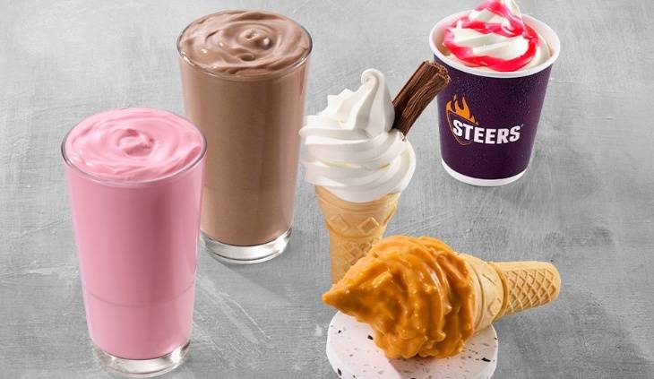 Assorted milkshakes and soft serve ice cream desserts including strawberry and chocolate shakes, waffle cones and creamy sundaes